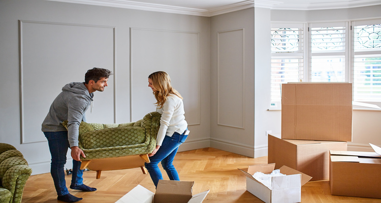 mortgages near gouverneur ny image of happy couple moving furniture in to new home with move in boxes