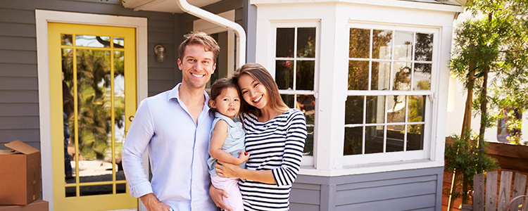 pmi private mortgage insurance image of happy couple with baby standing in front of home from gouverneur savings and loan