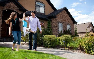 pmi private mortgage insurance image of happy family playing in front yard in front of home